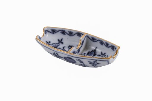 A closeup of a ceramic vintage ashtray under the lights isolated on a white background