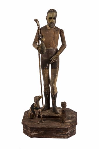 A vertical shot of a statue of an old man isolated on the white background