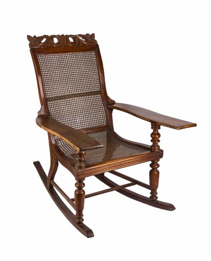 A vertical shot of a rocking chair under the lights isolated on a white background