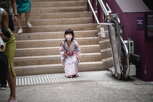 A little girl dressed in pink and blue kimono excited at her trip to the Flower Dome