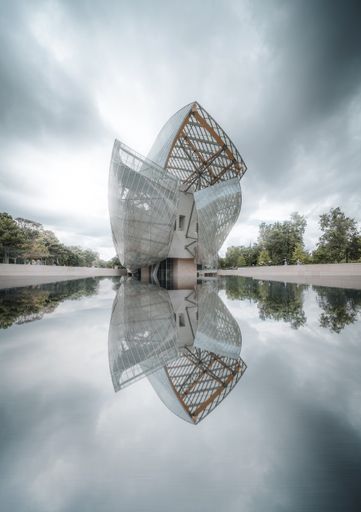 A vertical shot of the Louis Vuitton Foundation reflected in the water, Paris, France