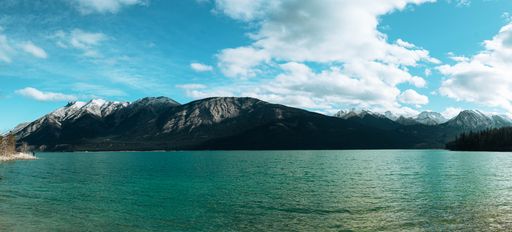 A beautiful view of a lake surrounded by snow-capped mountains in Canada
