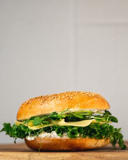 A vertical closeup of the burger on the table.