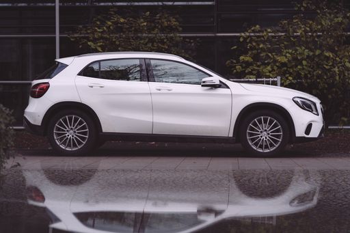 A Mercedes Benz A-Class parked in Munich, Germany in the autumn next to an office building