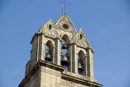 A low angle shot of the top part of an old church bell tower in Spain