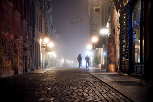 An urban scenery of silhouettes of people walking in the street at night in Slovenia,Ljubljana