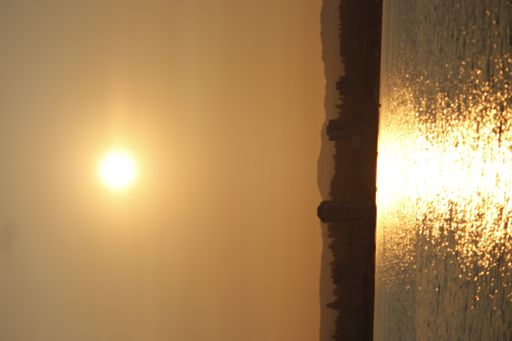A beautiful view of sunset over the sea with a water reflection