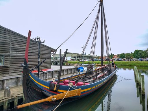 A beautiful shot of an Authentic ship of Vikings in Roskilde harbor Marina in Denmark with blue sky