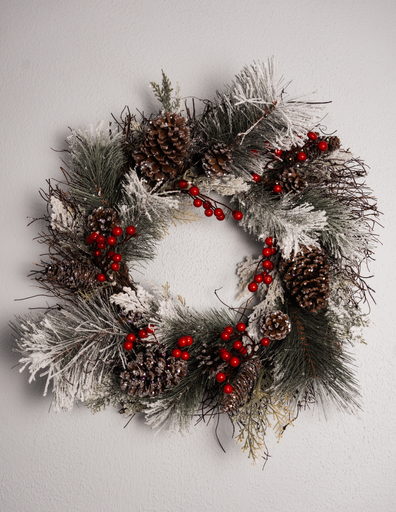 A closeup of a Christmas wreath on a white surface