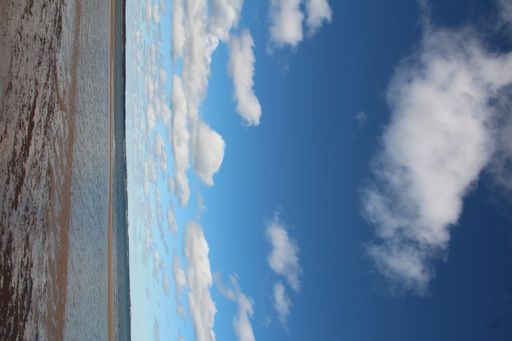 A beautiful view of sea waves on the beach under the blue sky