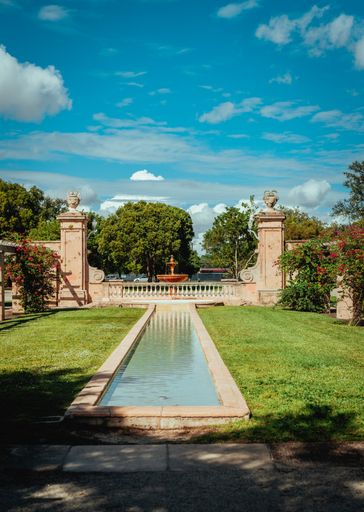 A beautiful view of a park with fountains and trees