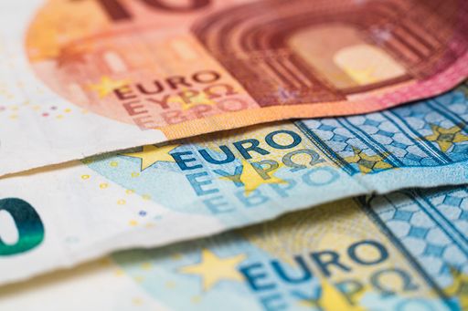 Macro photograph of the word euro on a euro banknote. European monetary system. The ECB prints money and buys bonds. Danger of inflation
