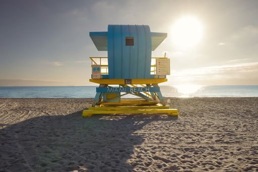 A blue lifeguard tower on the beach during sunset in South Pointe Park, Miami, Florida