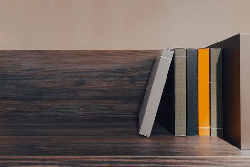 A wooden bookshelf with organized books