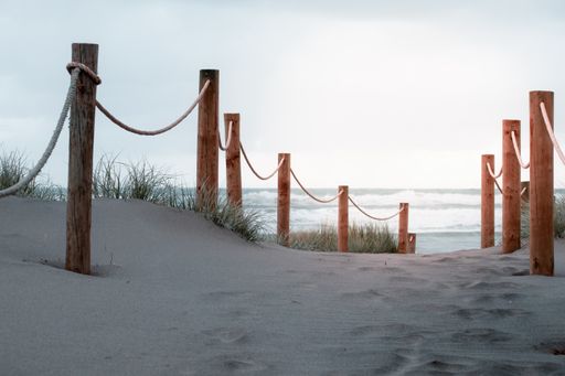 View oPathway in dunes with wood post fence
