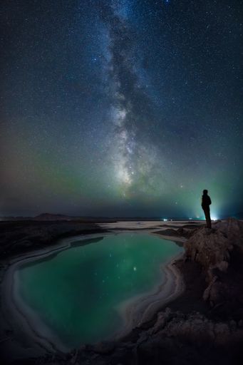 A vertical shot of the Lencois Maranhenses National Park and a male under the starry night sky