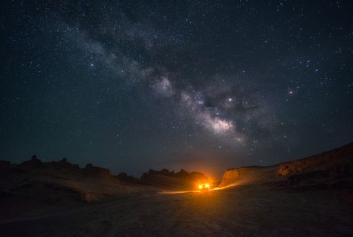 A scenic view of the car under the starry night sky