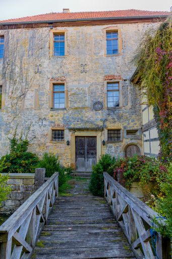 A vertical shot of an old building through the Grabfeld at the gates of Franconia - Thuringia