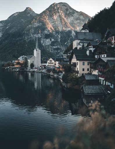 A beautiful shot of Hallstatt village in Austria surrounded by greenery-covered mountains
