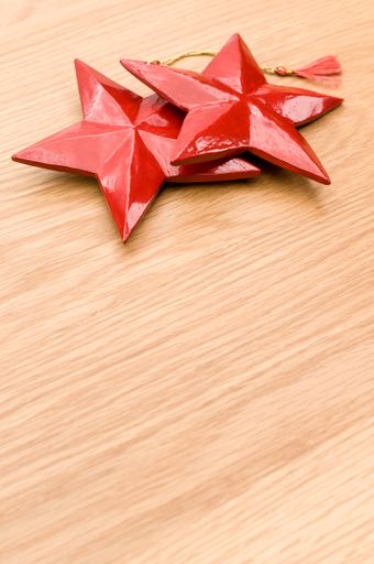 red painted decorative wooden star on a wooden background with copy space