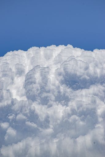 A vertical shot of the beautiful cloudscape in the blue sky.