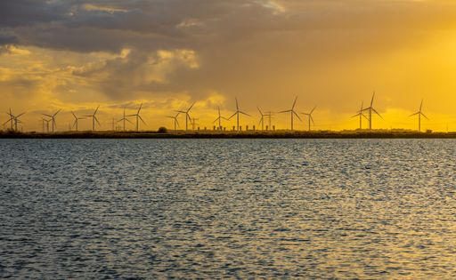 Wind turbines nearby lake Binnenschelde in Bergen op Zoom during beautifully coorful sunset