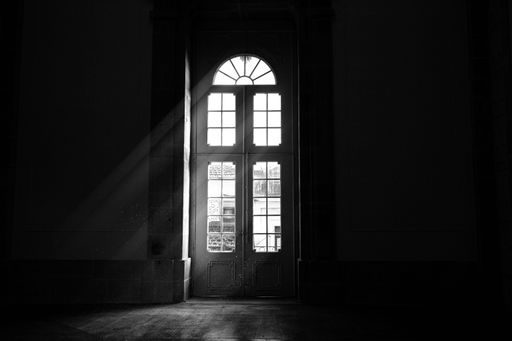 A grayscale shot of light coming in through a door