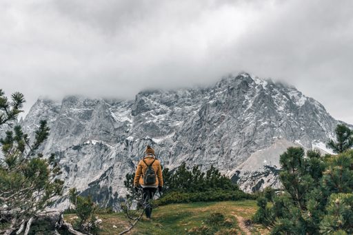 A beautiful view of a female hiker walking on a path in mountains in the alps in Croatia