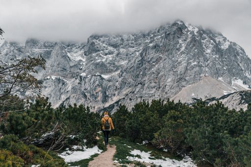 A beautiful view of a female hiker walking on a path in mountains in the alps in Croatia