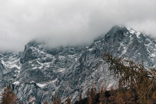 A beautiful view of the moody and cloudy sky over mountain peaks in Julian Alps in Slovenia
