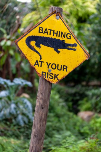 A warning sign of danger crocodiles, bathing at your risk