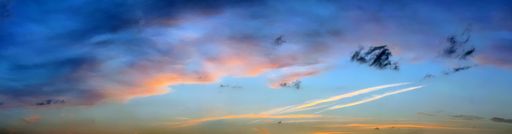 A panoramic shot of a breathtaking colorful cloudy sky at sunset
