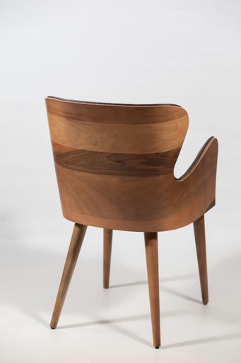A behind shot of a wooden chair isolated on a white background