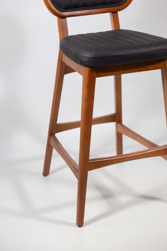 A vertical shot of a wooden chair on a white surface