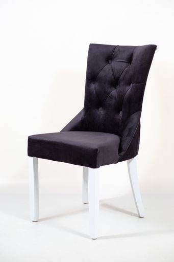 A vertical shot of a dark grey chair on a white surface