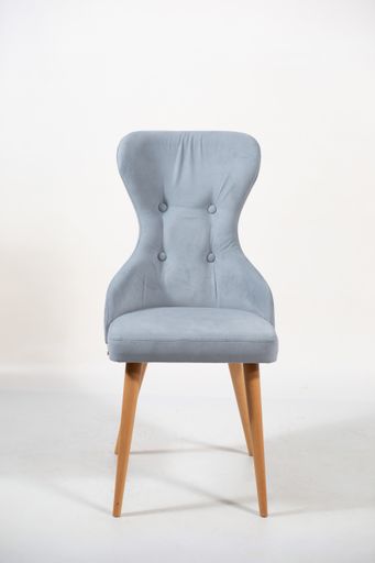 A vertical shot of a grey chair behind a white surface