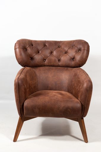 A vertical shot of a brown leather armchair on a white chair
