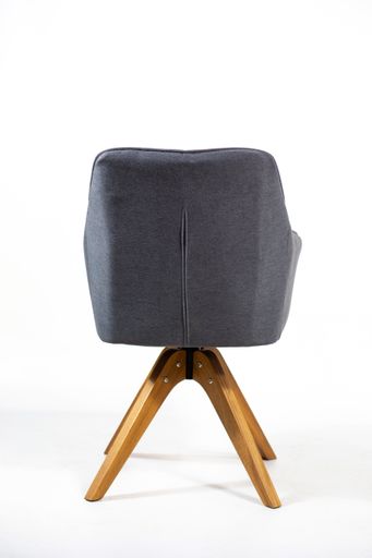 A vertical shot of the back of a gray chair behind a white background