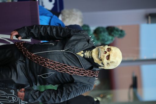 A vertical shot of a Ghost rider man with metal chains in the street in Whitby, UK