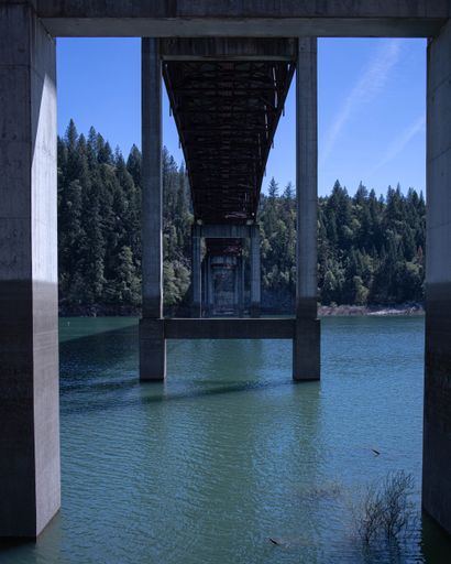 A vertical shot of the bridge above the river.