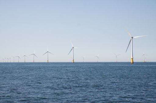 Wind turbines in an offshore wind farm in the North Sea just off the coast of the Netherlands, on a clear day.