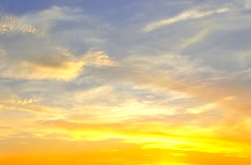 A panoramic mesmerizing shot of a cloudy colorful sky during sunset