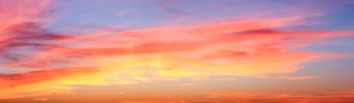 A panoramic shot of a breathtaking colorful cloudy sky at sunset