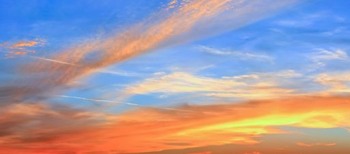 A panoramic shot of a breathtaking colorful cloudy sky at sunset