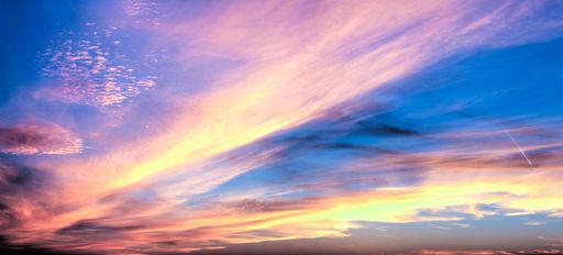 A panoramic shot of a breathtaking colorful cloudy sky at sunset