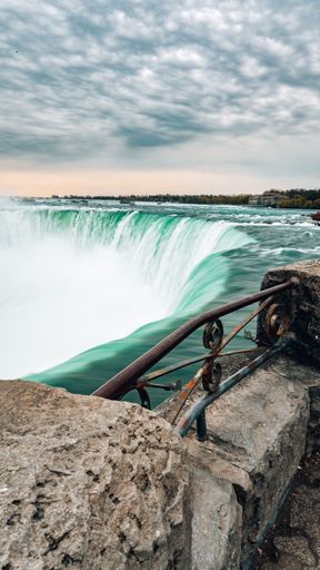 A vertical shot of a Niagara Falls in Canada under the cloudy skies