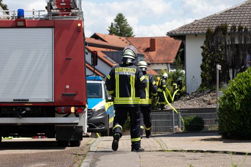 A closeup of German firefighters hard at work during daylight