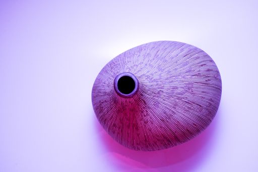 A high angle shot of an abstract clay vase