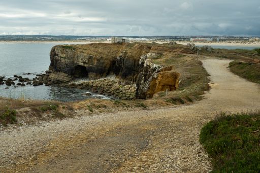 A beautiful shot of a small peninsula in the Peniche under the cloudy skies