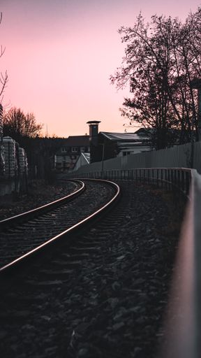 A vertical shot of a railway during the sunset